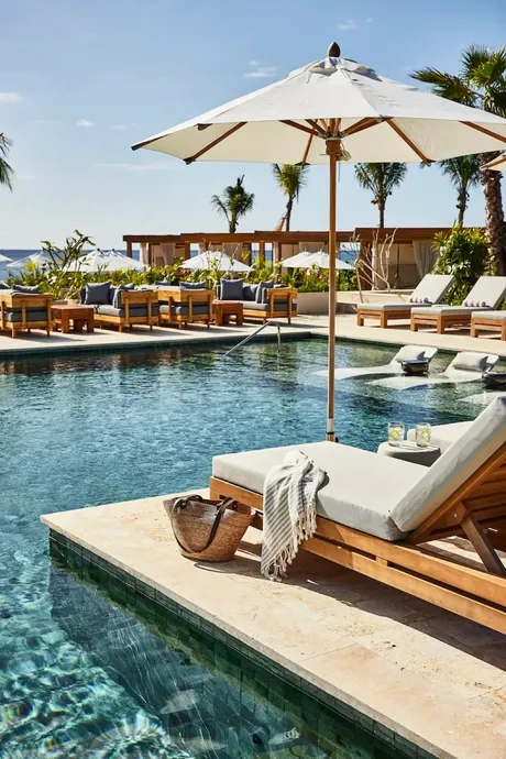 Sun loungers and an umbrella beside the pool