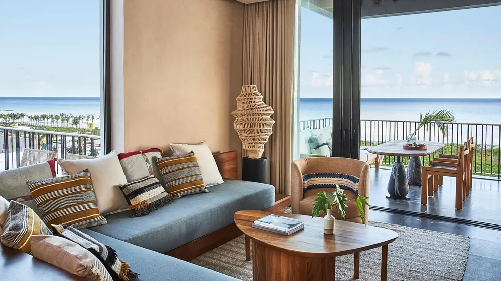 A suite living room opening onto an ocean-view terrace